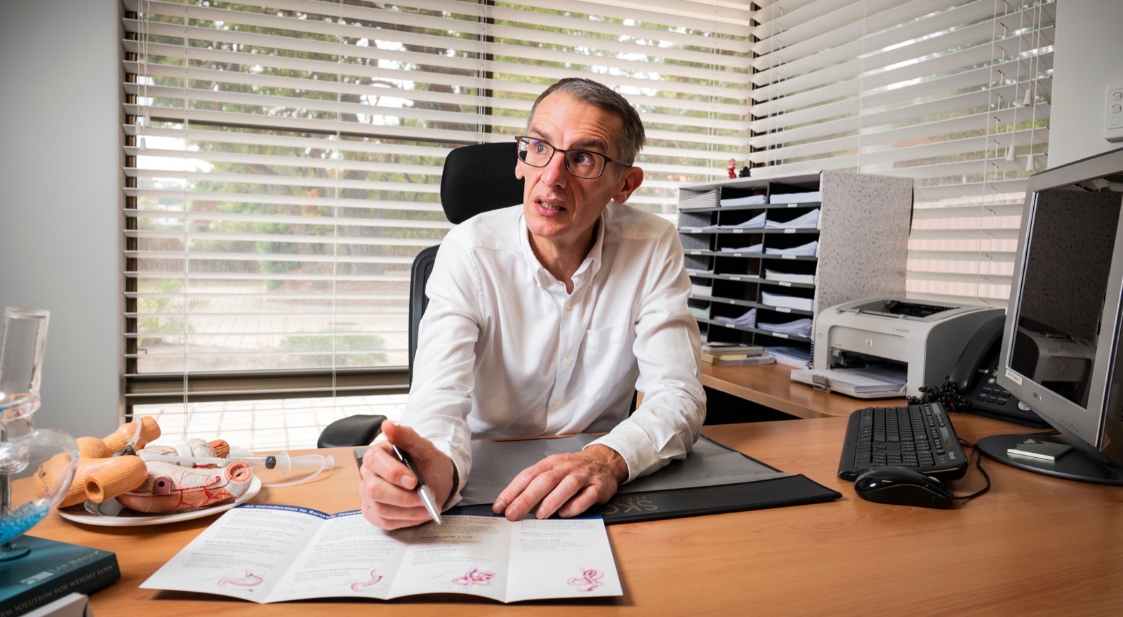 Dr Kevin Dolan in consultation at his desk.