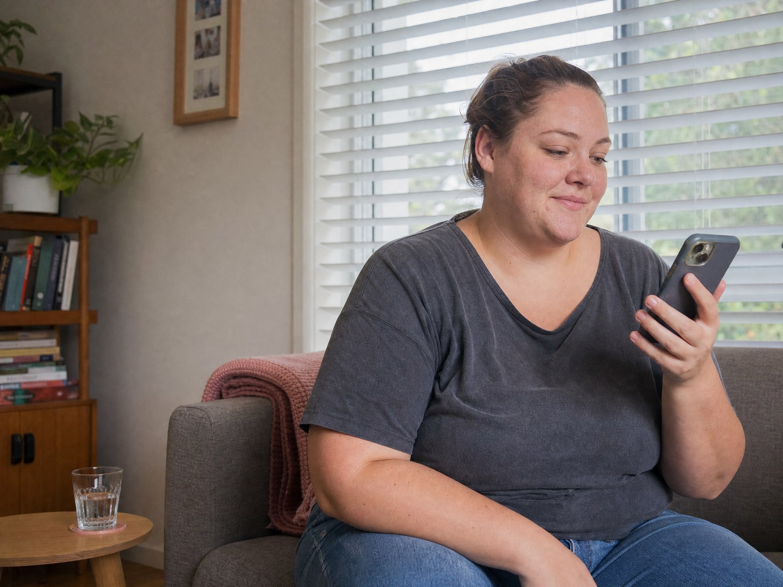 A patient at home reviewing her clinical assessment on her phone.